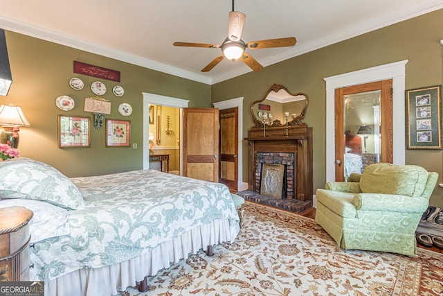 bedroom with a ceiling fan, a fireplace, and crown molding