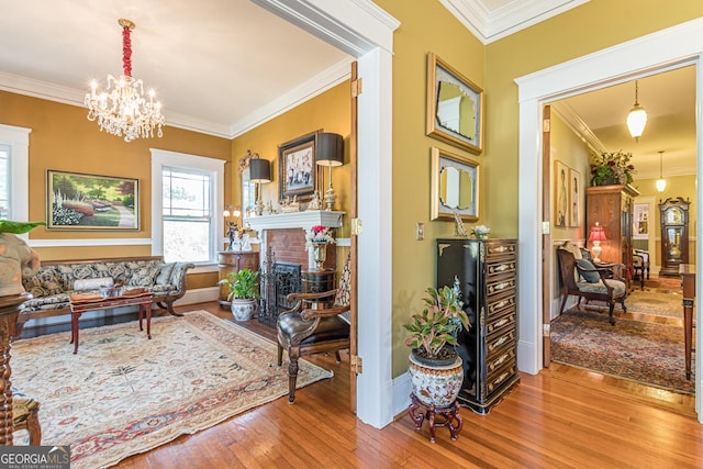 interior space with ornamental molding, wood-type flooring, and a fireplace