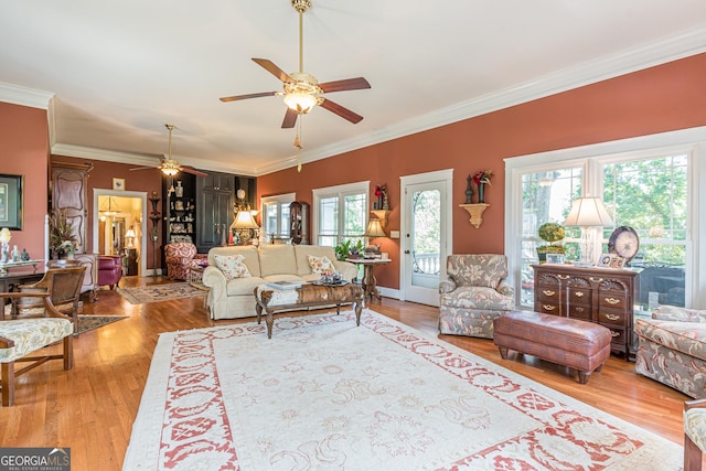 living room featuring a ceiling fan, ornamental molding, and wood finished floors