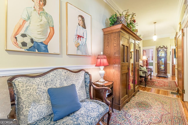 sitting room featuring crown molding and wood finished floors