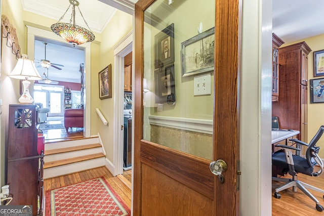 hall featuring baseboards, french doors, wood finished floors, and crown molding