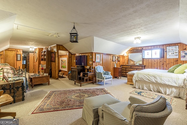 carpeted bedroom with lofted ceiling and wood walls