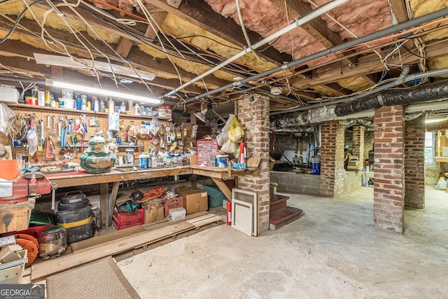 unfinished basement featuring a workshop area