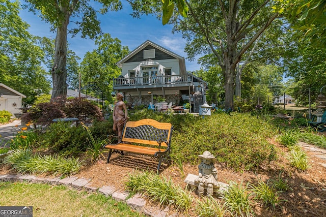 rear view of property featuring stairs and a wooden deck