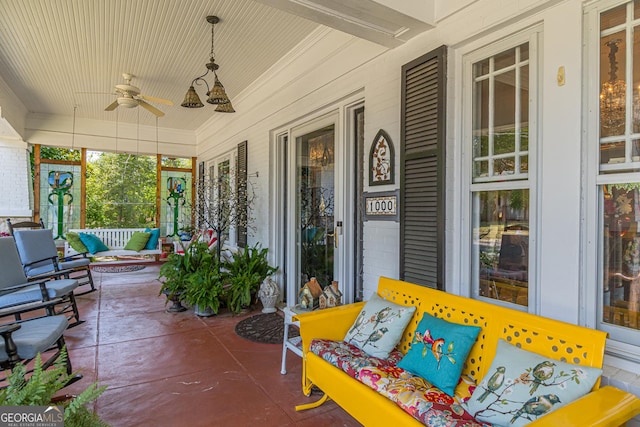 view of patio / terrace with a ceiling fan, an outdoor fire pit, and covered porch