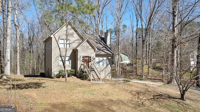 view of front of house with a chimney and a front yard