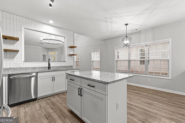 kitchen featuring dishwasher, open shelves, light wood-type flooring, and a sink