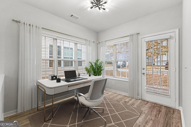 office with visible vents, baseboards, and wood finished floors