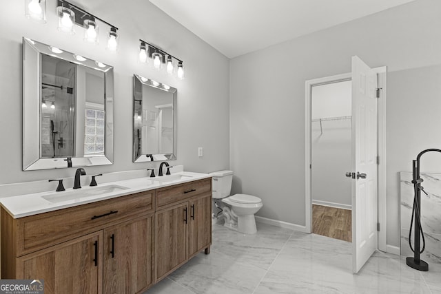 full bath with marble finish floor, a sink, and double vanity