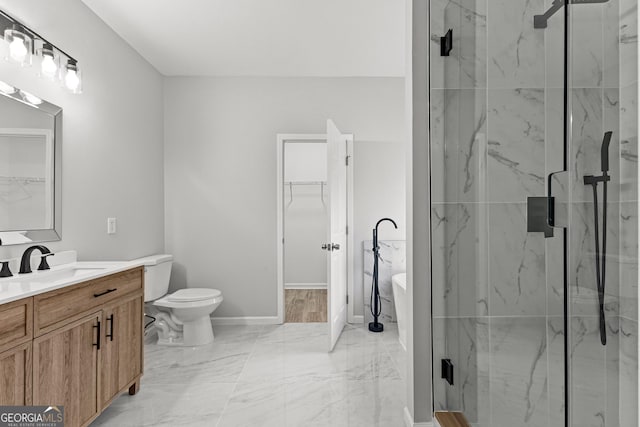 full bath featuring a freestanding bath, marble finish floor, a marble finish shower, and vanity