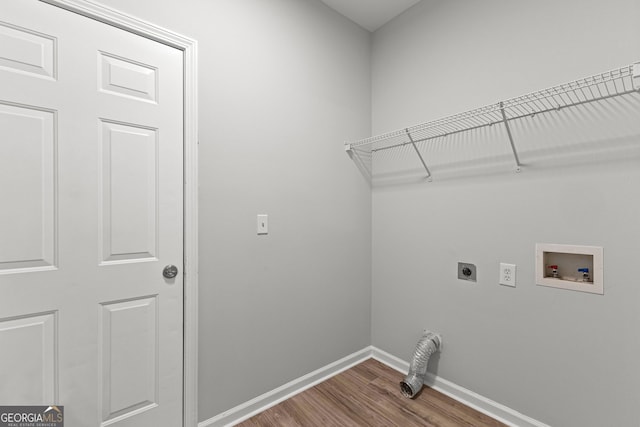 laundry room with washer hookup, dark wood finished floors, electric dryer hookup, laundry area, and baseboards