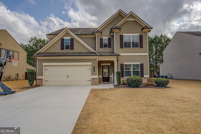 craftsman-style house featuring a garage, concrete driveway, brick siding, and a front lawn