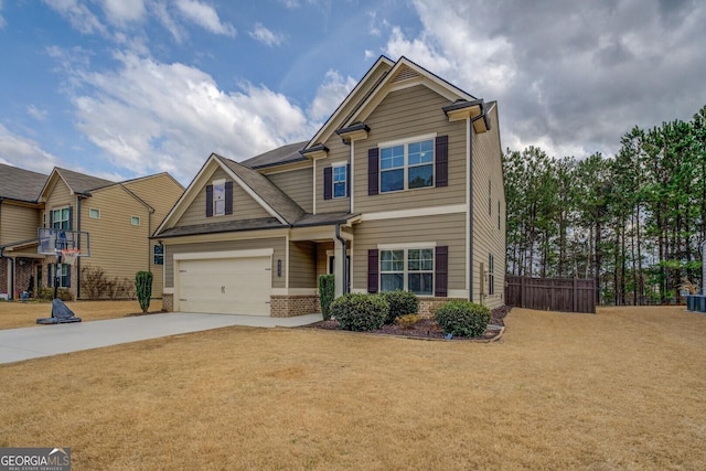 craftsman house with driveway, a garage, fence, a front lawn, and brick siding