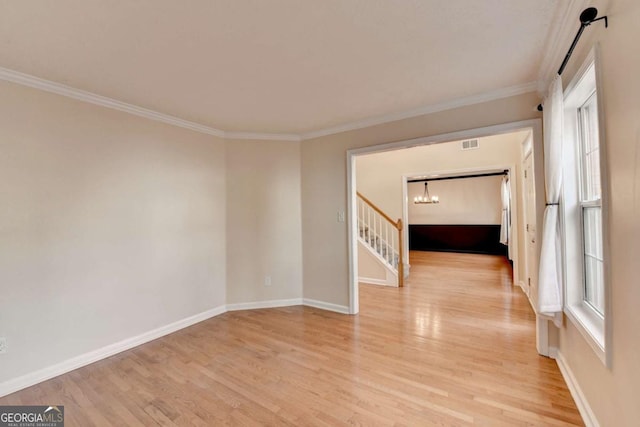 unfurnished room with light wood-style flooring, baseboards, and ornamental molding