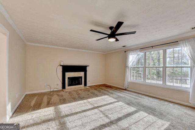 unfurnished living room featuring a fireplace with flush hearth, a ceiling fan, baseboards, ornamental molding, and carpet