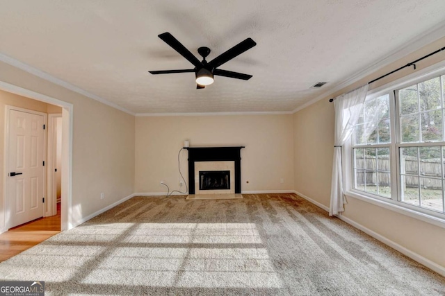 unfurnished living room with a fireplace with flush hearth, a healthy amount of sunlight, and crown molding