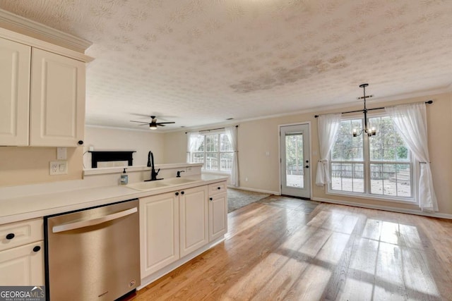 kitchen with a peninsula, a sink, stainless steel dishwasher, light wood finished floors, and crown molding