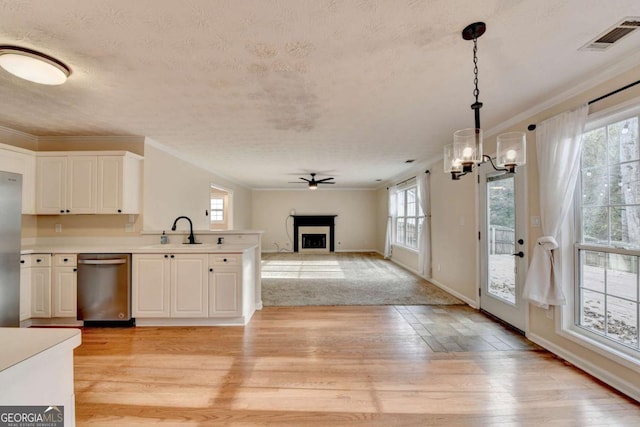 kitchen featuring a fireplace, a sink, visible vents, appliances with stainless steel finishes, and light wood-type flooring