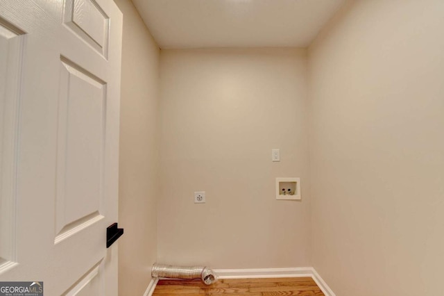 laundry room with hookup for a washing machine, hookup for an electric dryer, laundry area, wood finished floors, and baseboards