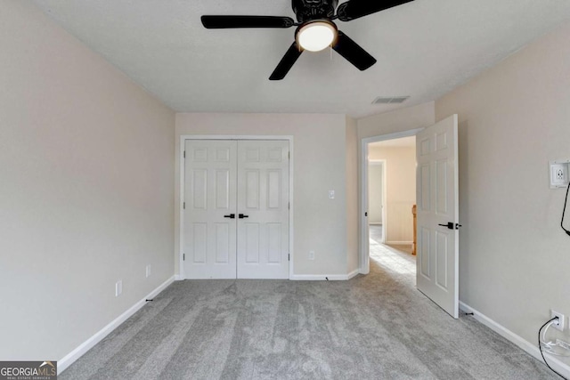 unfurnished bedroom with carpet, a closet, visible vents, a ceiling fan, and baseboards