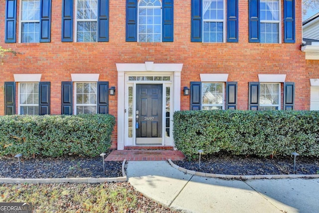 entrance to property with brick siding