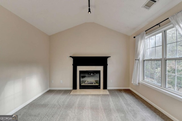 unfurnished living room with vaulted ceiling, carpet floors, visible vents, and baseboards