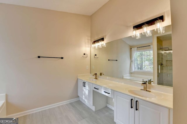 bathroom with double vanity, a stall shower, a sink, and a bath