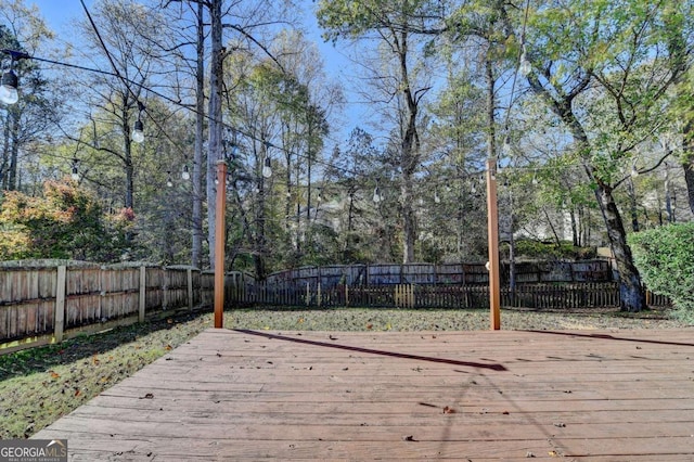 wooden deck featuring a fenced backyard