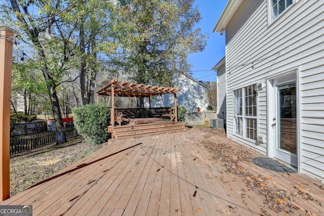 wooden terrace featuring central AC, fence, and a pergola