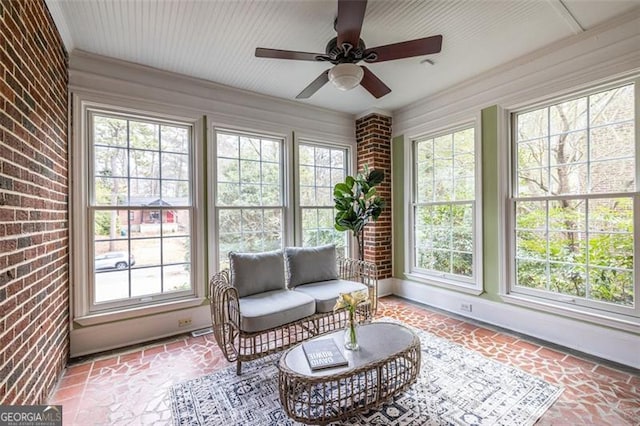 sunroom / solarium featuring a wealth of natural light and a ceiling fan