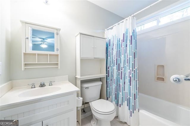 bathroom with tile patterned floors, vanity, toilet, and shower / bath combo with shower curtain