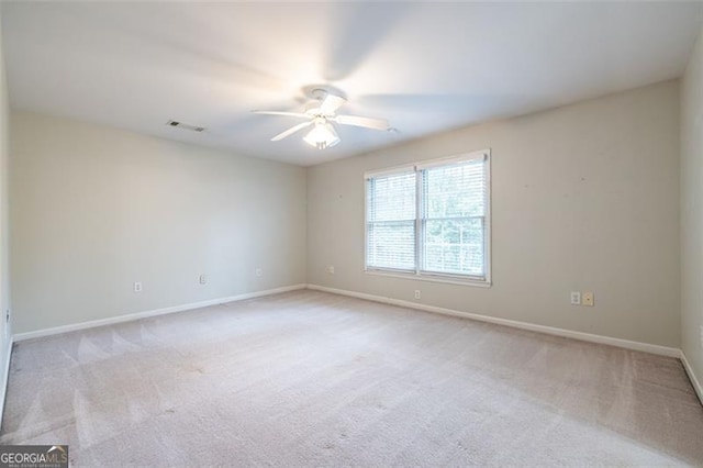 unfurnished room featuring a ceiling fan, baseboards, visible vents, and carpet flooring