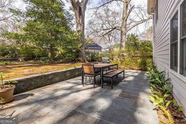 view of patio / terrace featuring fence and outdoor dining area