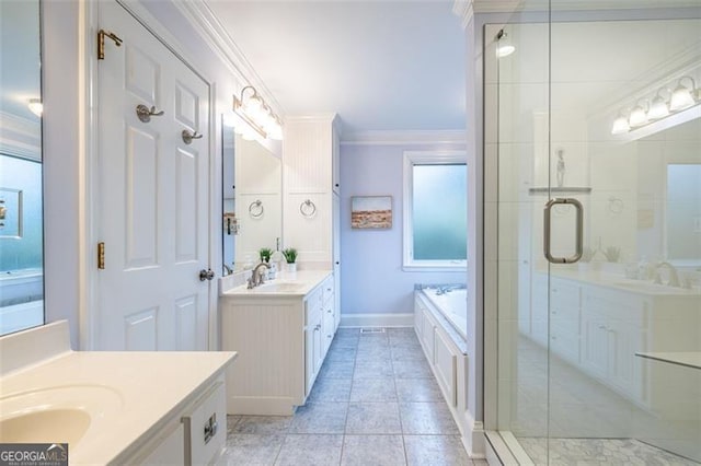 bathroom with ornamental molding, two vanities, a sink, and a garden tub