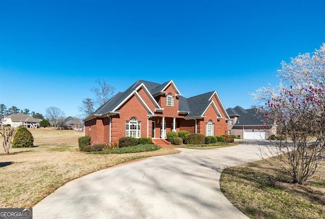 view of front facade with brick siding and a front lawn