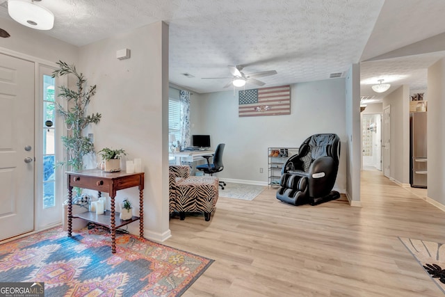 entrance foyer with visible vents, a ceiling fan, a textured ceiling, wood finished floors, and baseboards