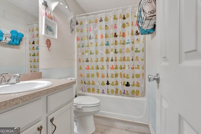 bathroom featuring shower / bath combo, vanity, toilet, and wood finished floors