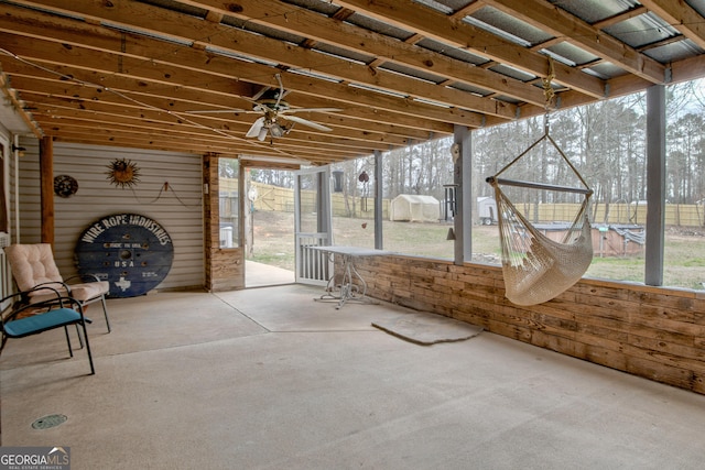 unfurnished sunroom with a ceiling fan