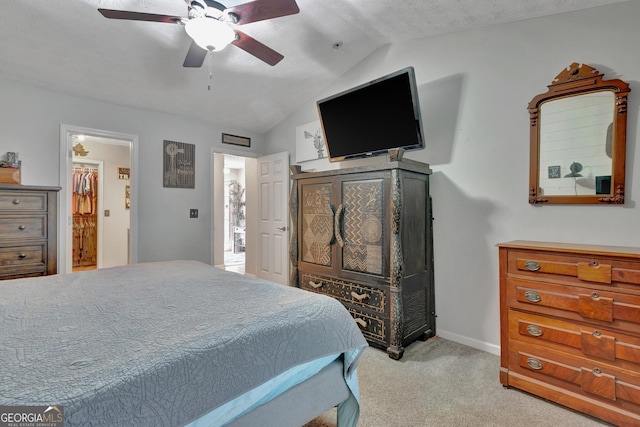 bedroom with lofted ceiling, light colored carpet, ceiling fan, and baseboards