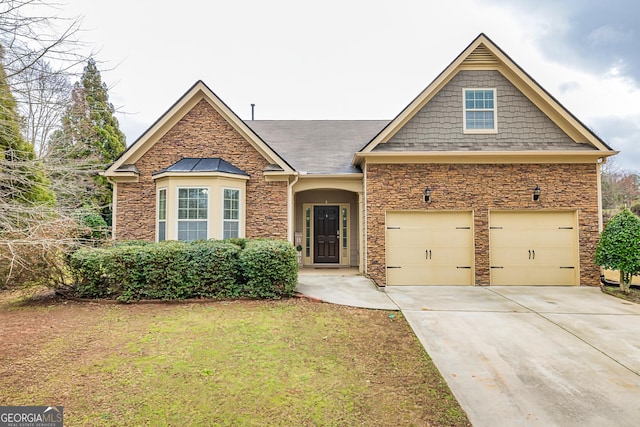 view of front of house with a garage, concrete driveway, and a front lawn