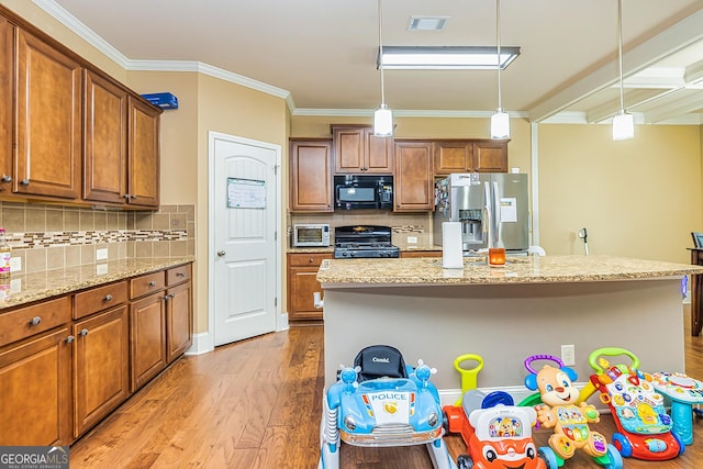 kitchen featuring light wood finished floors, visible vents, ornamental molding, brown cabinets, and black appliances