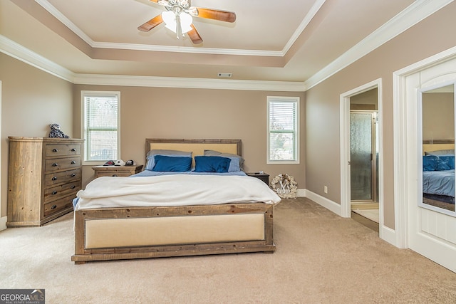 bedroom with light colored carpet, a tray ceiling, visible vents, and crown molding