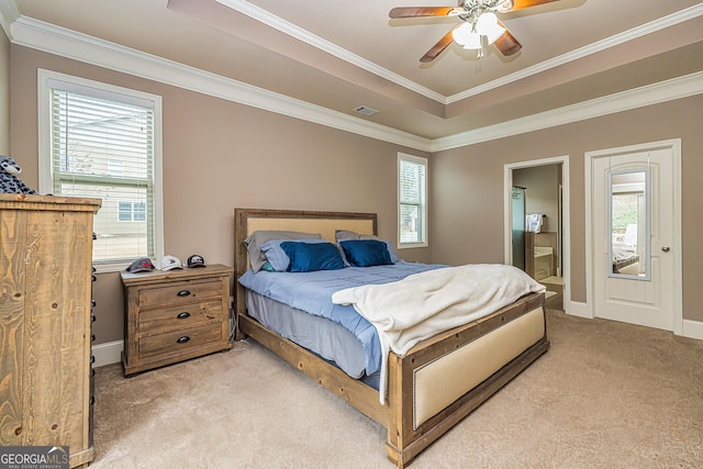 bedroom featuring light carpet, multiple windows, a raised ceiling, and crown molding