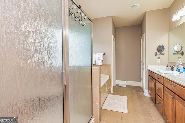 bathroom with double vanity, a stall shower, a sink, tile patterned flooring, and a bath