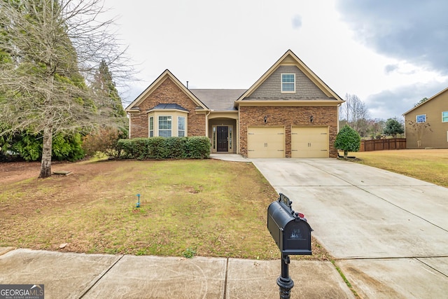 view of front of property featuring a garage, driveway, a front yard, and fence