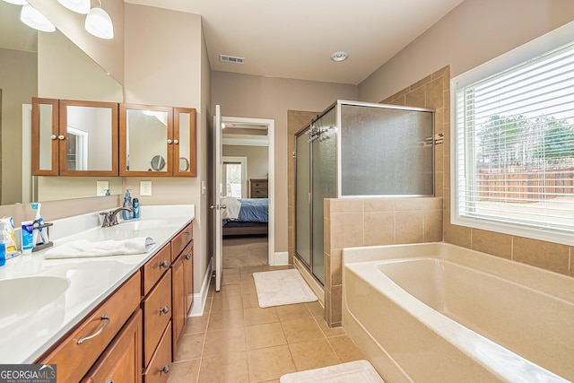 ensuite bathroom with a garden tub, a sink, visible vents, tile patterned floors, and a stall shower