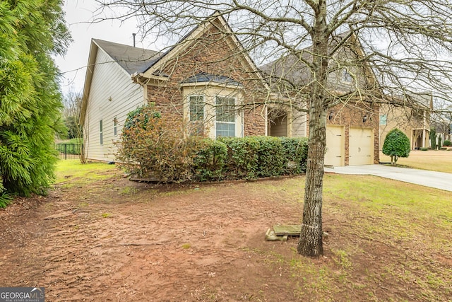 view of front of property with a garage and concrete driveway