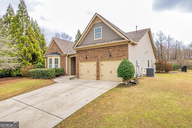 view of front of home featuring a garage, a front yard, concrete driveway, and central air condition unit