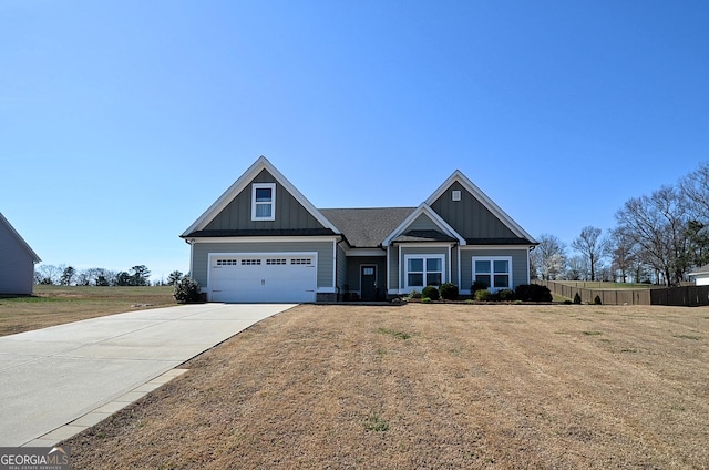 craftsman house with a garage, a front yard, board and batten siding, and concrete driveway