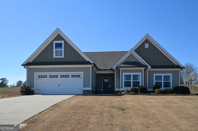 craftsman inspired home with a garage, concrete driveway, roof with shingles, board and batten siding, and a front yard